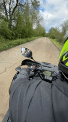 Motorcyclist rides through rural Bulgarian village roads