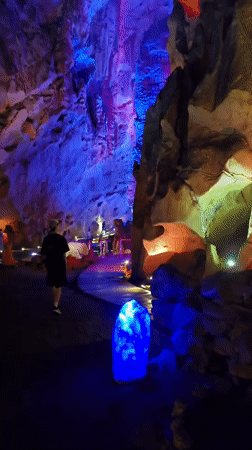 Tourists visit illuminated cave attraction in Xihu District, China