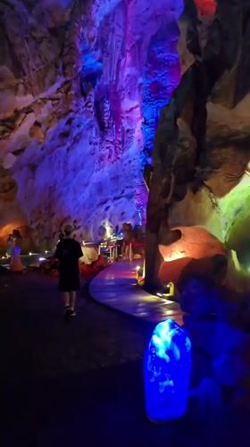 Tourists visit illuminated cave attraction in Xihu District, China