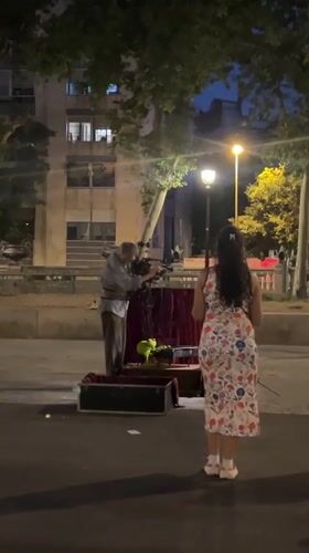 Barcelona's Palau de la Generalitat at night, with street performance nearby