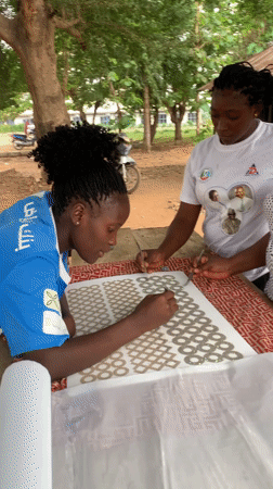 Women craft with metallic items outdoors in Maigizo, Nigeria