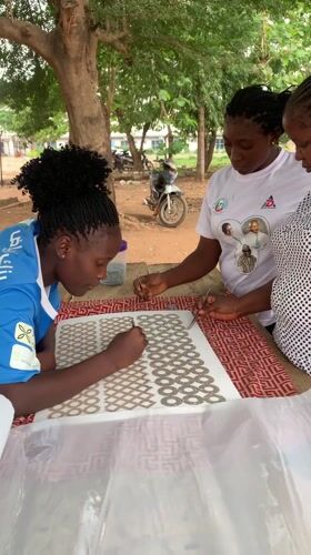 Women craft with metallic items outdoors in Maigizo, Nigeria