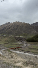 Rural Georgian village scene documented near mountain foothills