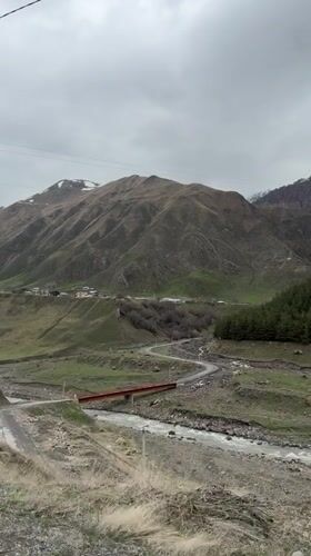 Rural Georgian village scene documented near mountain foothills