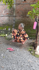 Elderly woman spends quiet moments in Baron yard
