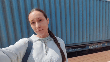 Woman films selfie video near shipping container in Domodedovo