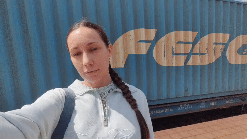 Woman films selfie video near shipping container in Domodedovo