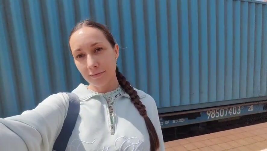 Woman films selfie video near shipping container in Domodedovo