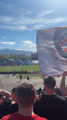 Soccer fans pack stadium in red and black