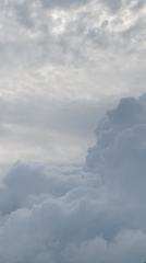 Cloudy skies filmed over green hillside in Unwana, Nigeria