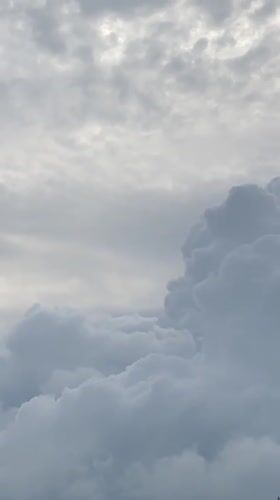 Cloudy skies filmed over green hillside in Unwana, Nigeria