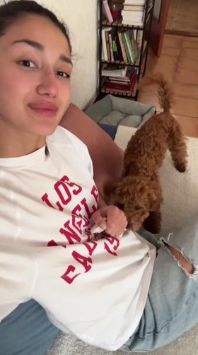 Woman films video with poodle in Montenegro apartment