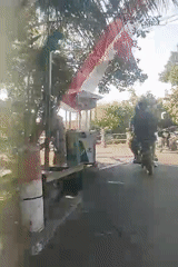 Motorbikes and street life in a Surabaya residential neighborhood
