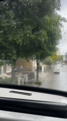 Heavy rain obscures London street view from vehicle