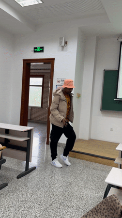 Man dances with phone in empty Beijing classroom