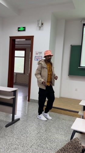 Man dances with phone in empty Beijing classroom