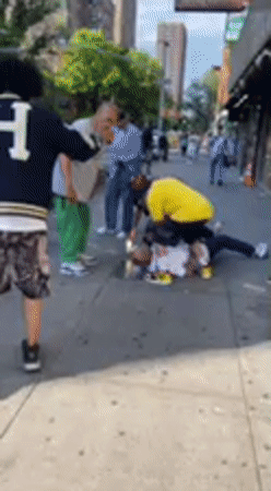 Man on ground draws crowd on NYC sidewalk