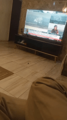 Resident watches international news while dining at home in Nigeria