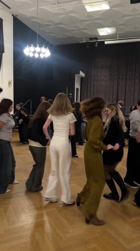Young women dance in Strasbourg venue with wooden floors