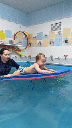 Child paddles on foam float in Russian pool