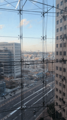 Ramat Gan street scene captured through geometric window