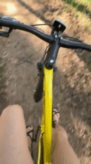 Yellow bicycle rider travels waterfront paths and city streets