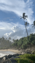 Tourist documents scenic Ahangama beach during morning coastal visit