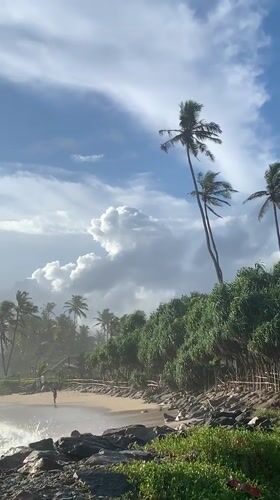 Tourist documents scenic Ahangama beach during morning coastal visit