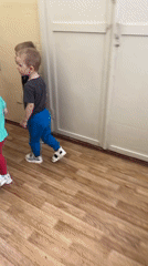 Preschoolers follow teacher through Saint Petersburg kindergarten building