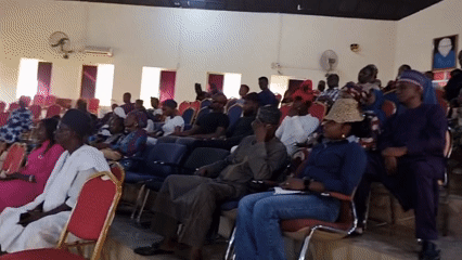 Crowd gathered in tiered hall for event in Barden Yana