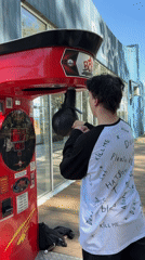 Young man uses punching bag machine in Chaikovsky