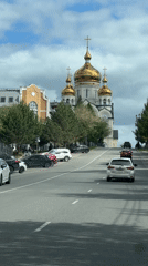 Traffic flows past Orthodox church in Khabarovsk