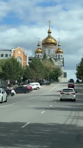 Traffic flows past Orthodox church in Khabarovsk