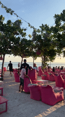 Sunset beach socializing and pink café scenes captured in Indonesia