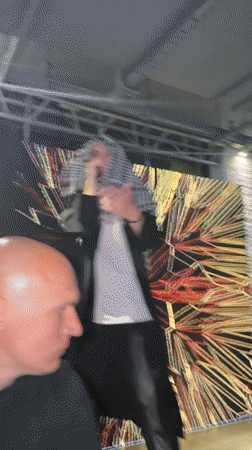 Live stage performance in Novaya Usman' with geometric gold backdrop