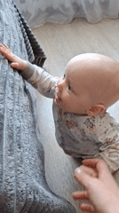 Baby pulls up on furniture in developmental milestone moment