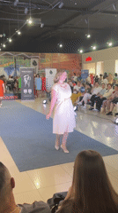 Indoor mall fashion show on a blue runway in Russia