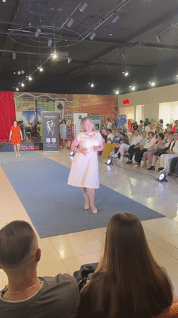 Indoor mall fashion show on a blue runway in Russia