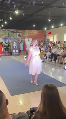 Indoor mall fashion show on a blue runway in Russia