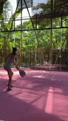 Woman plays padel tennis on pink court in Philippines