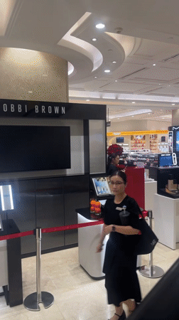 Browsing luxury beauty counters at a Thủ Đức department store