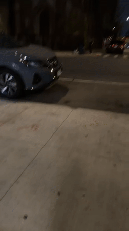 Nissan SUV parked on New York street during nighttime