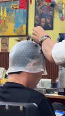 Customer gets hair highlights at Hero Barber Shop, Nha Trang