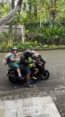 Family on scooter observed in tropical Kuta Selatan driveway