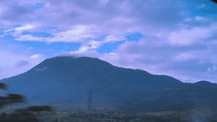 Mountain range filmed from moving vehicle in Lonbaroh, Indonesia