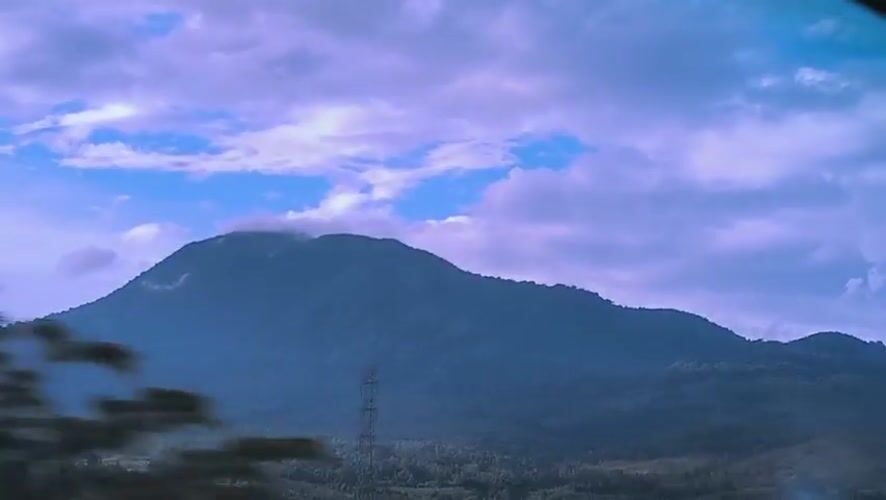 Mountain range filmed from moving vehicle in Lonbaroh, Indonesia