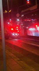 Motorcycle, bus wait at red light in Kiryat Bialik