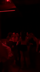 Evening social gathering at red-lit Dubai nightclub captured