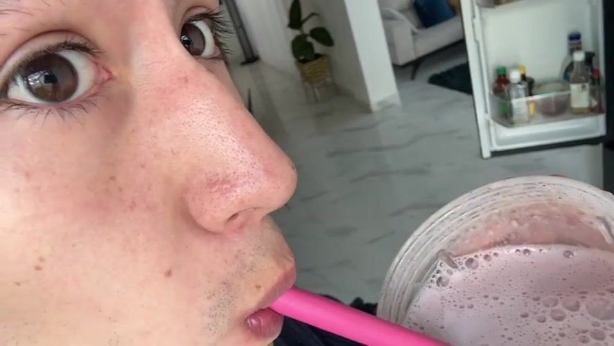 Young man makes pink berry smoothie in Mexican kitchen
