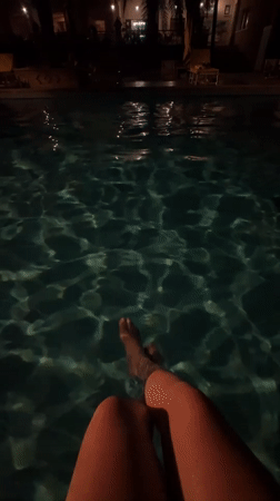 Person enjoys quiet poolside moment in Tozeur, Tunisia